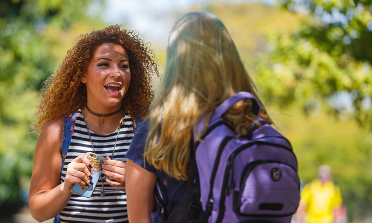 Two female students talking outside