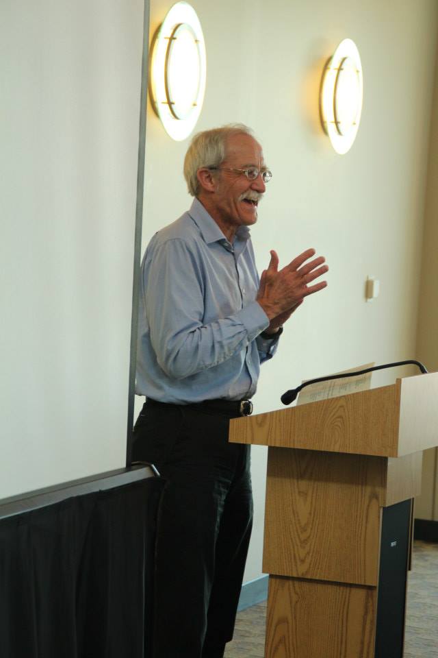 Professor David Crary speaks at a podium.