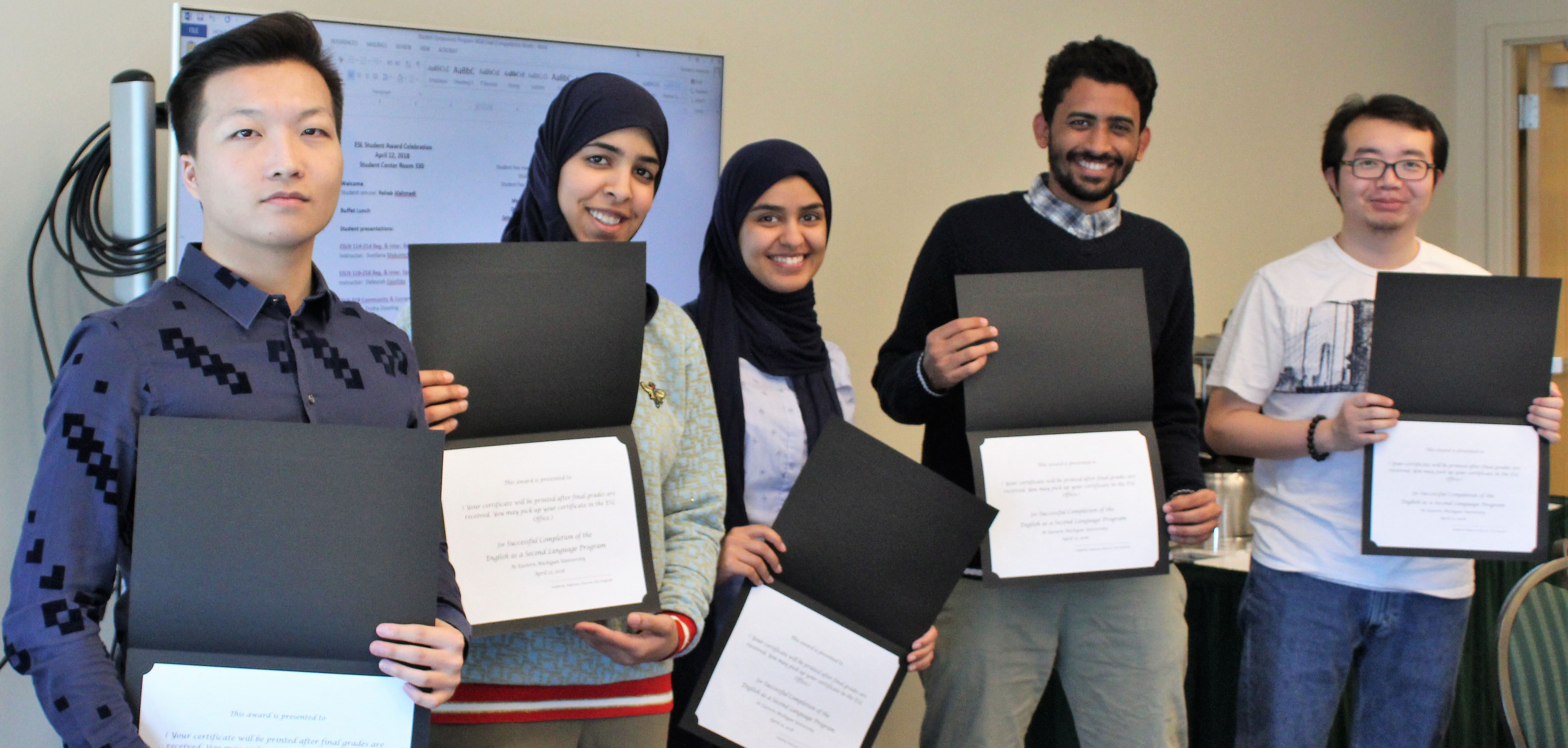 Five students stand with award certificates.