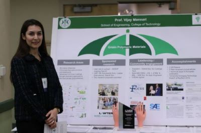 Professor Shakari with a poster at the 2019 showcase