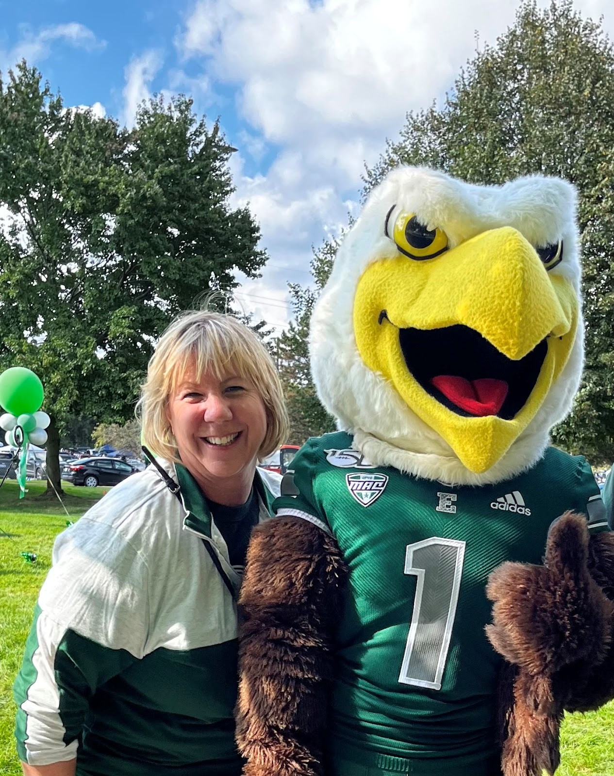 Image of Dr. Becker with EMU mascot, Swoops