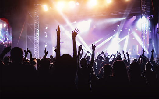 Crowd at a concert with bright lights and high energy