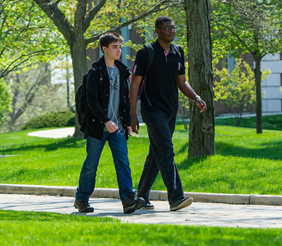 Students walking on campus in spring