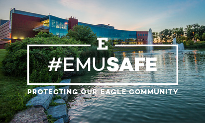 lake with student center in background and #emusafe branding over image