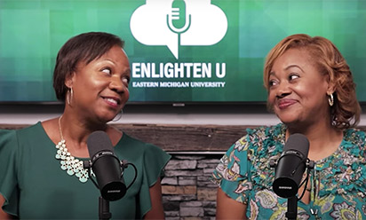 two women with microphones looking at each other; enlighten u podcast logo in the background