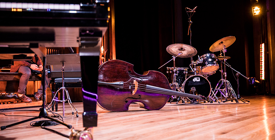 Jazz instruments on a shiny wooden floor.