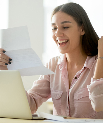 Happy young woman excited by reading good news in letter 