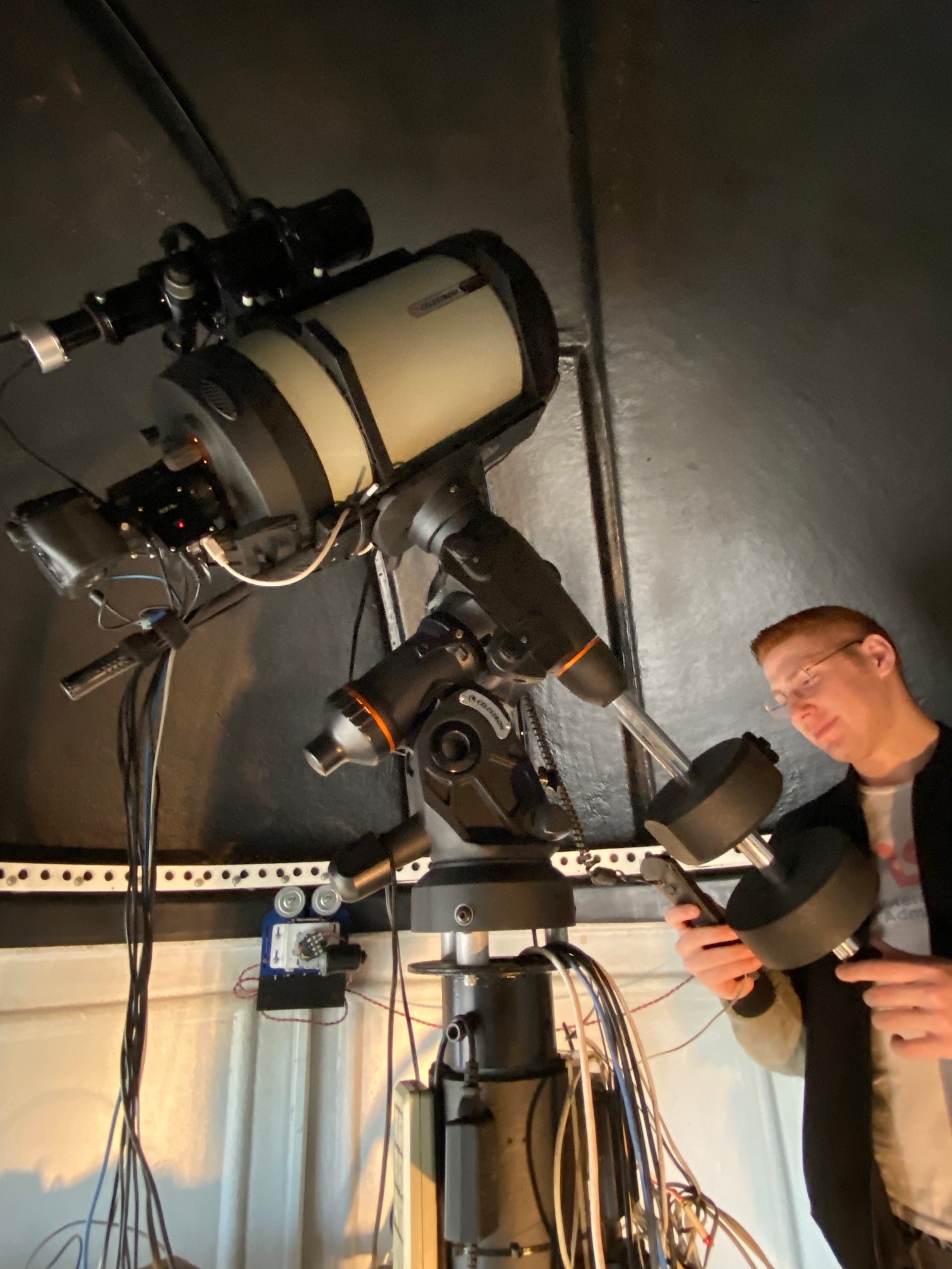     Astronomy Club President Miles Mercier works with the 9.25" imaging telescope inside the Sherzer Secondary Observatory.