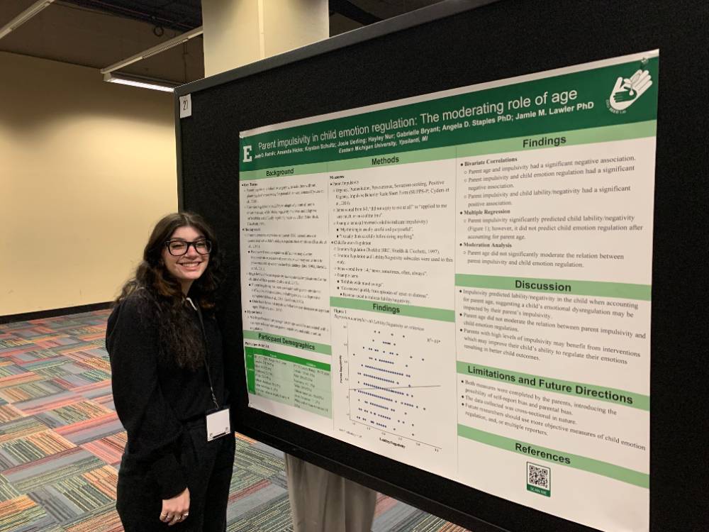 A photo of Joely Reznik presenting a research poster.