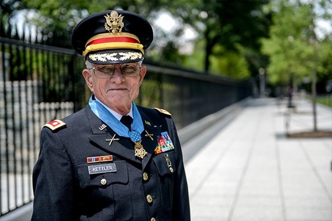A photo of Lt. Col. Charles Kettles standing by a black fence outdoors.